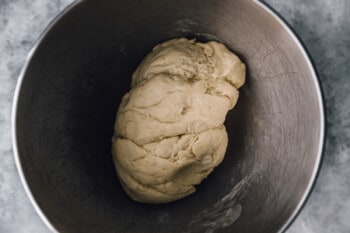 croissant dough in a stainless mixing bowl.