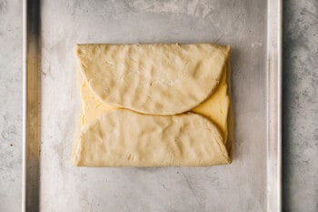 top and bottom third of croissant dough folded over butter.