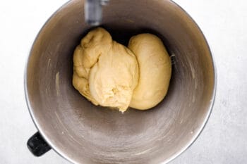 kneaded dinner roll dough in a stainless mixing bowl.