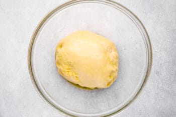 dinner roll dough in a glass bowl.