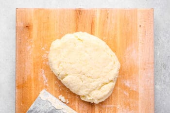 gnocchi dough on a wooden cutting board.