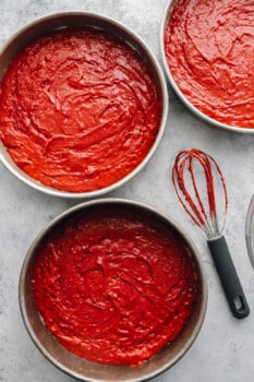 red velvet cake batter in 3 round cake pans.