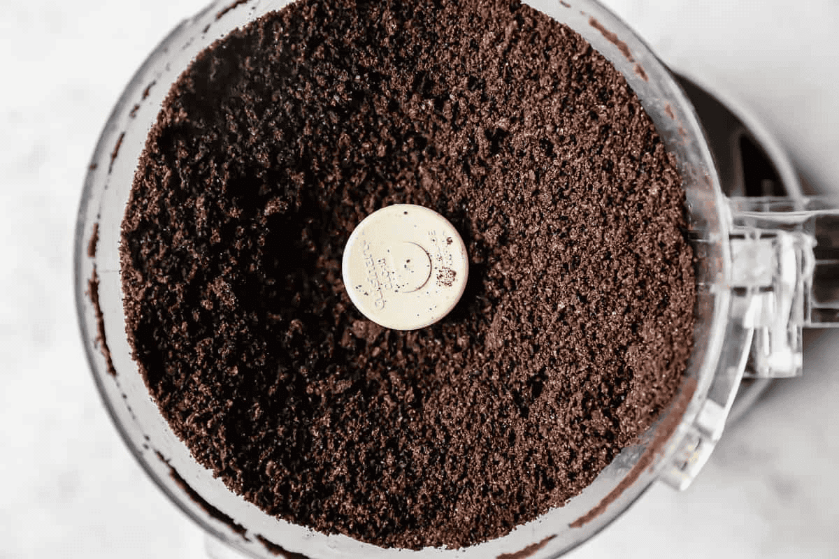 Oreo cookie crumbs in the food processor. 