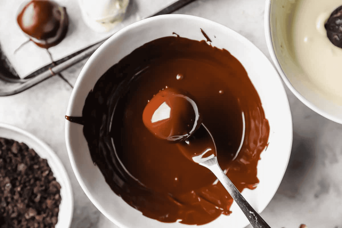 Dipping the Oreo balls into the melted chocolate. 
