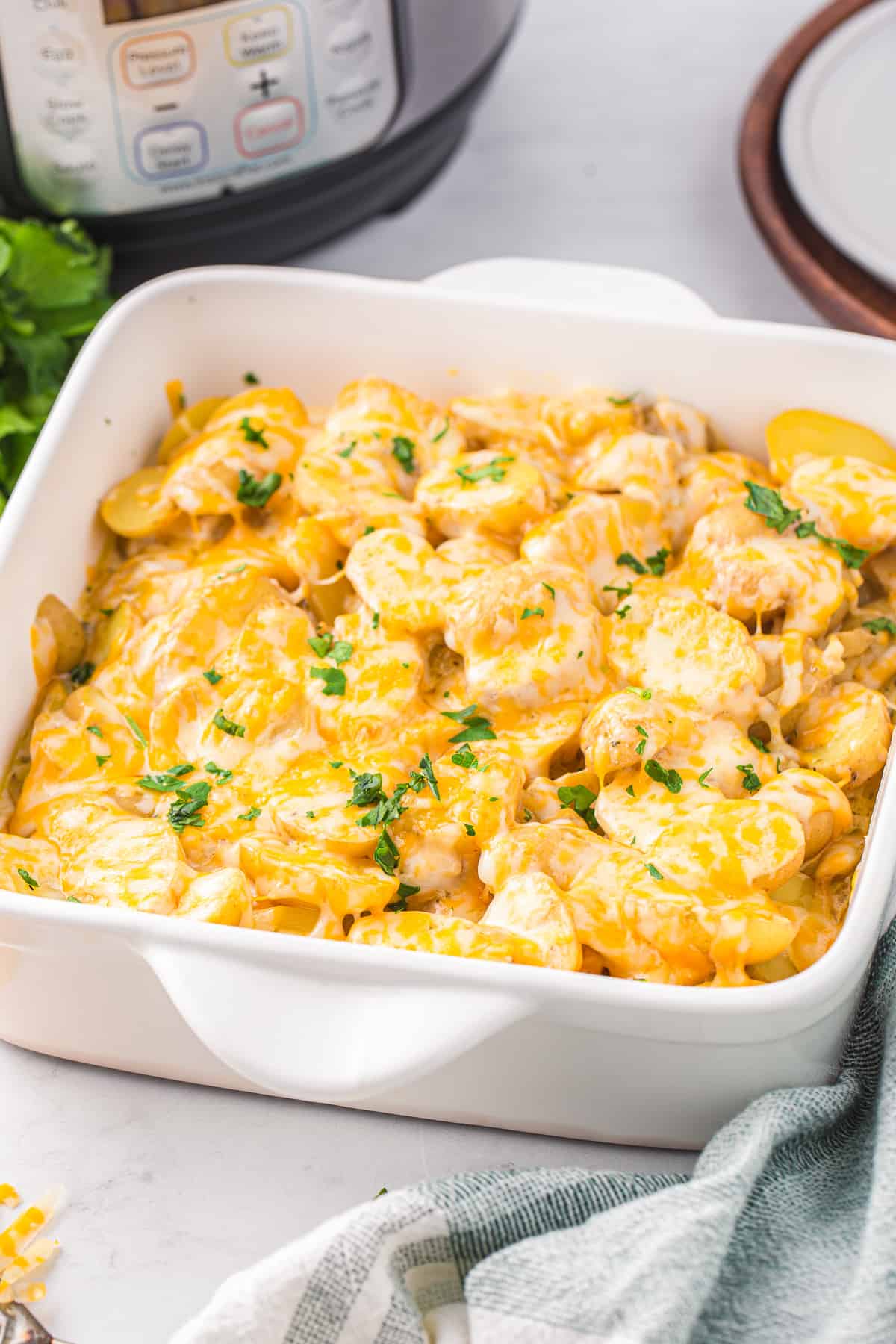 instant pot scalloped potatoes in a white square baking dish.