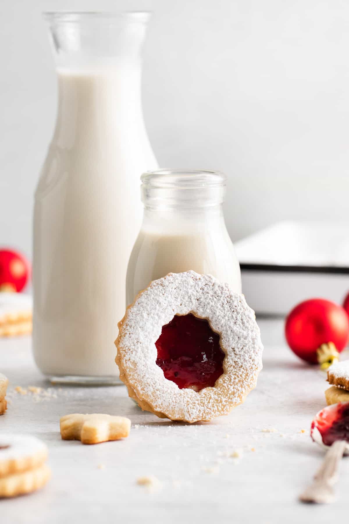 classic linzer cookie standing up again glasses of milk