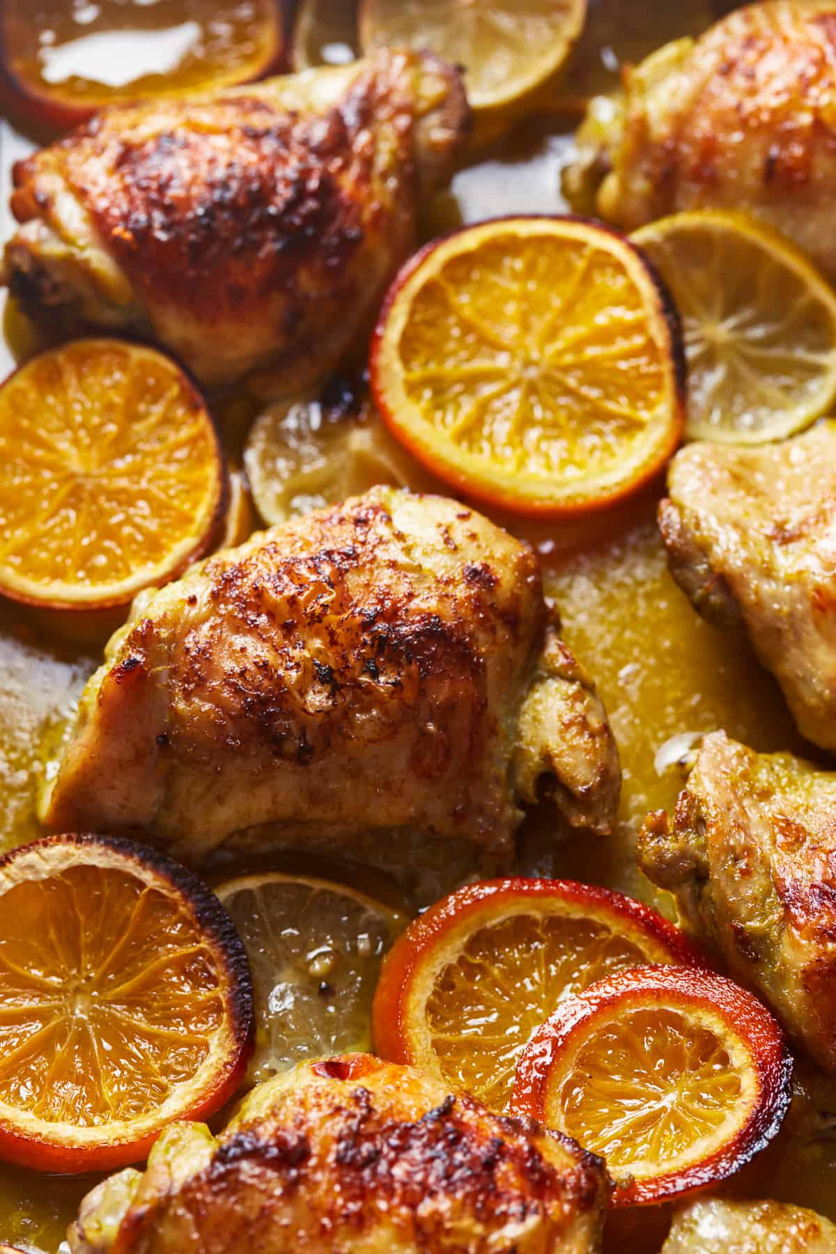 close up on baked mojo chicken with orange slices