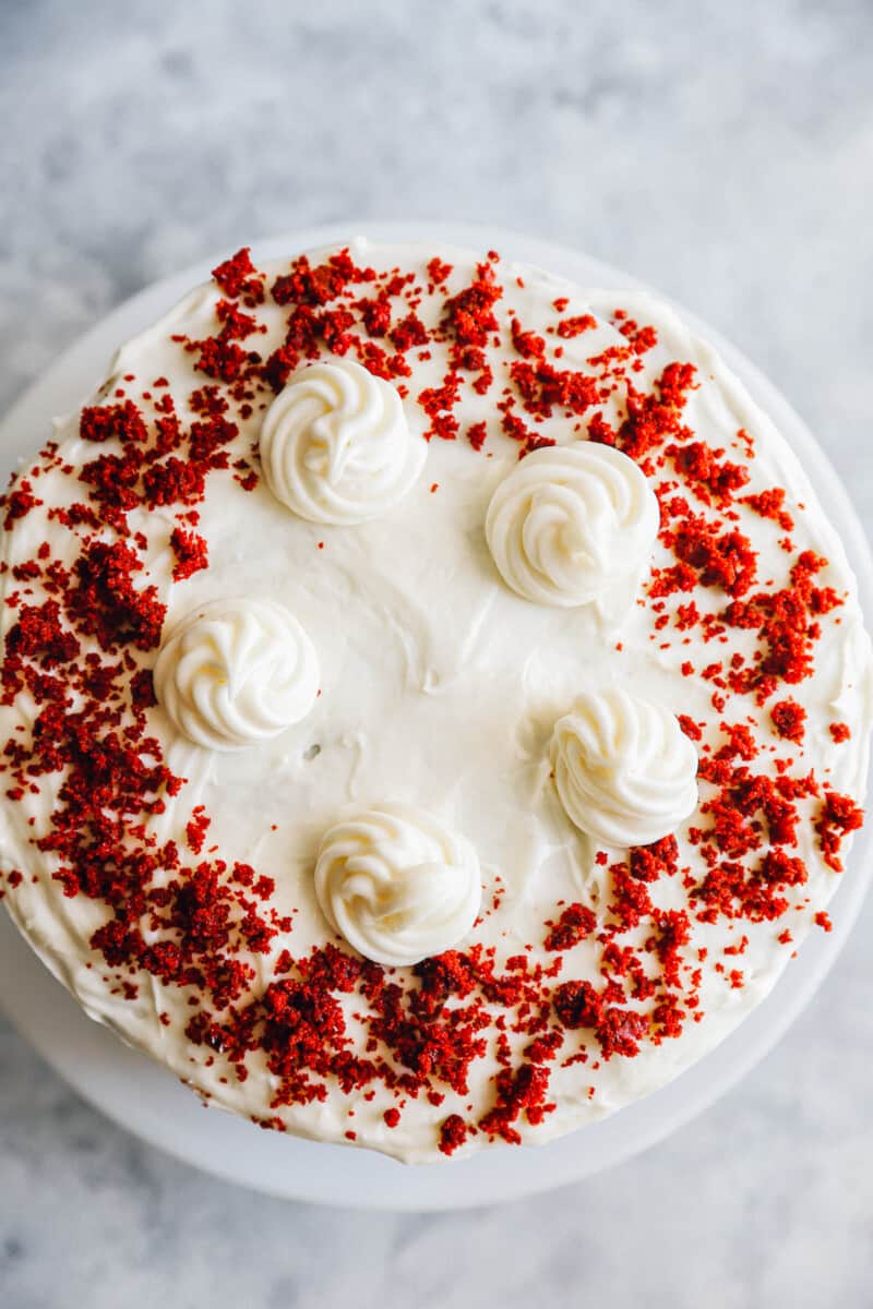 overhead view of red velvet cake on a white cake stand.