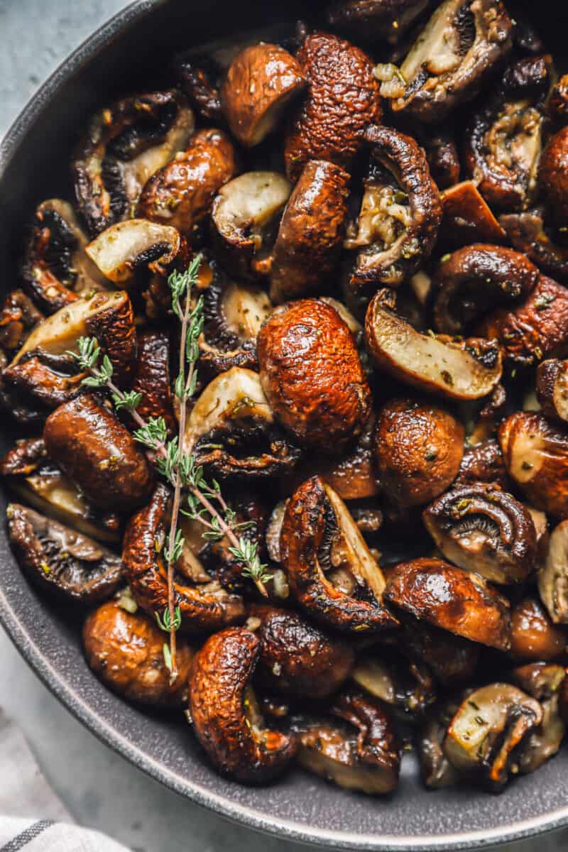 roasted mushrooms in a gray serving bowl.