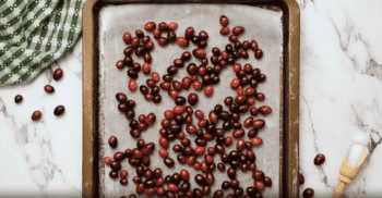 Sugared cranberries on a baking sheet.