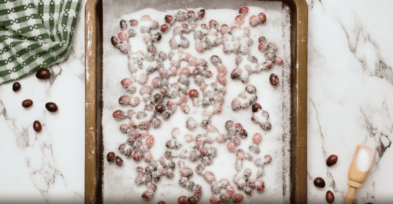 Sugared cranberries on a baking sheet.