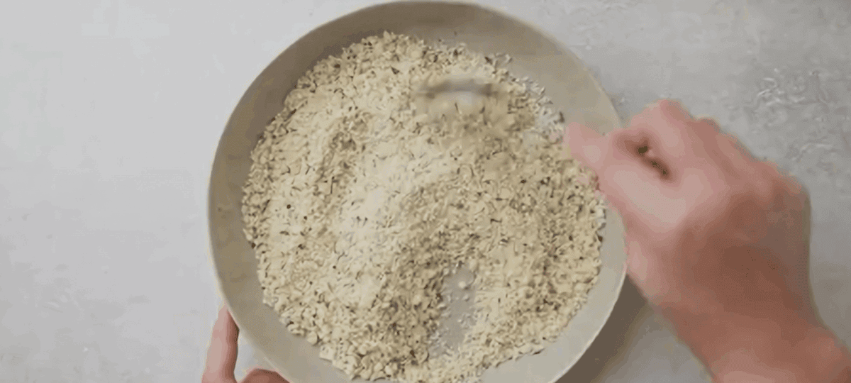 Preparing the seasoned breadcrumbs in a bowl.