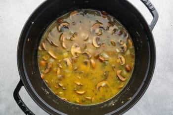 broth added to mushroom soup in a dutch oven.