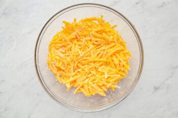 shredded cheese and cornstarch in a glass bowl.