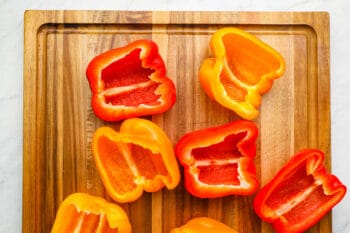 7 bell pepper halves on a cutting board.