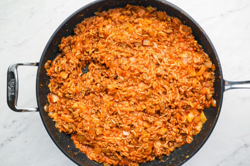 cooked ground beef and rice mixture for stuffed peppers in a frying pan.