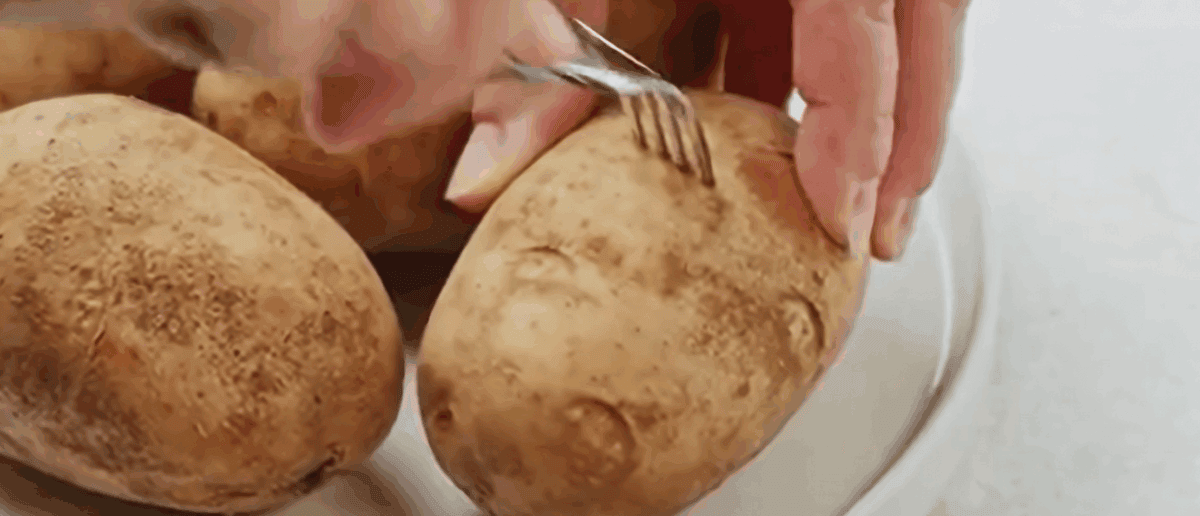 Piercing a potato with a fork. 