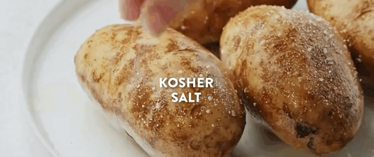 Seasoning the potatoes with olive oil and salt. 