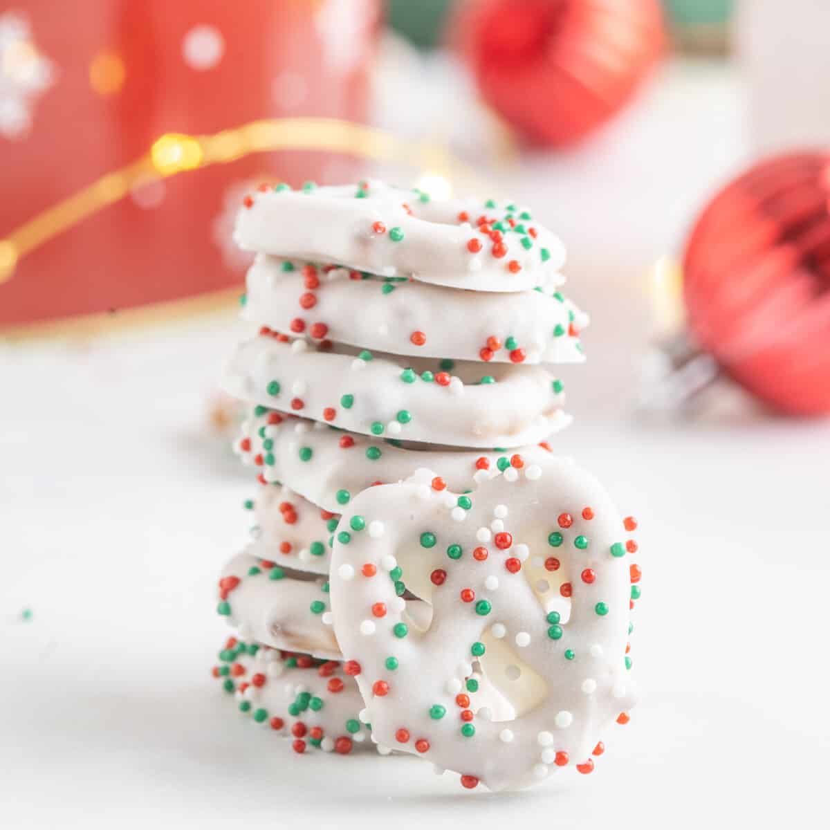 a stack of christmas pretzels with sprinkles.