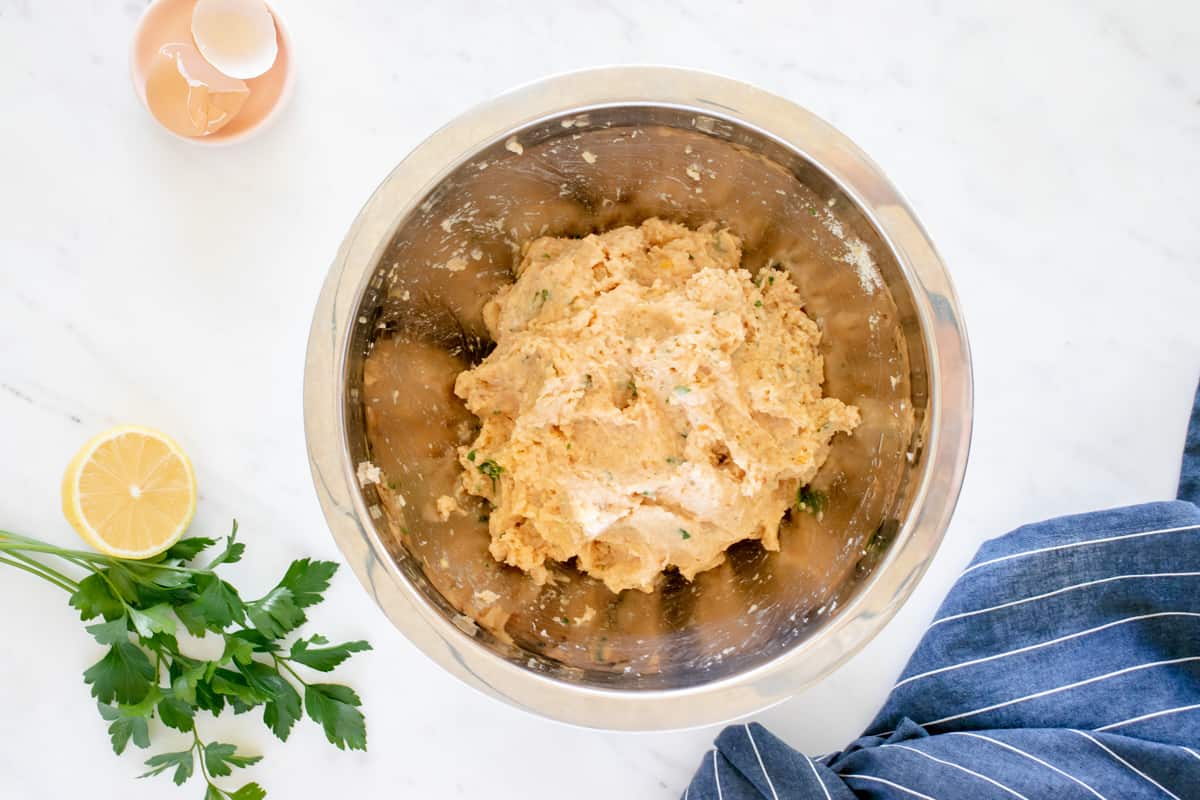 chicken piccata meatball mixture in a stainless steel mixing bowl.