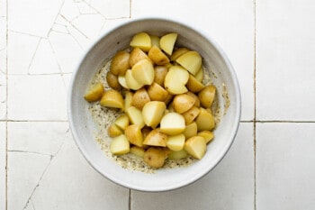 boiled diced potatoes in a white bowl.
