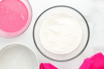 dry ingredients for pink velvet cake in a glass bowl.