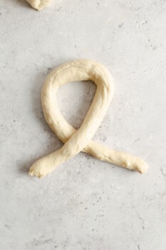 homemade pretzel dough log in a loop shape.