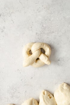 an uncooked homemade pretzel on a table.