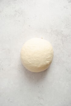 homemade pretzel dough ball on a counter.