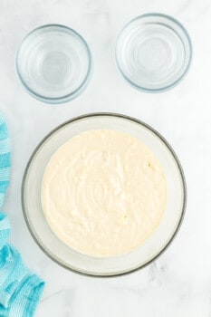 overhead view of rainbow cake batter in a glass bowl.