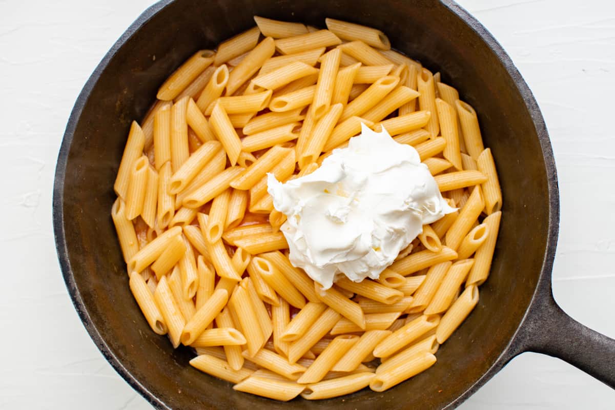 pasta and cheese in a cast iron pan.