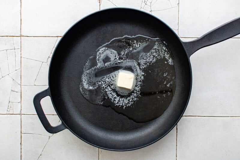 butter and oil melting in a cast iron skillet.