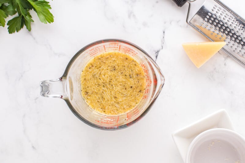 egg mixture for spaghetti carbonara in a liquid measuring cup.