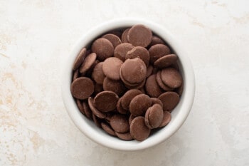 chocolate melting wafers in a white bowl.