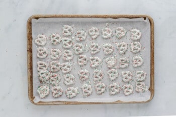 christmas pretzels on a baking sheet.