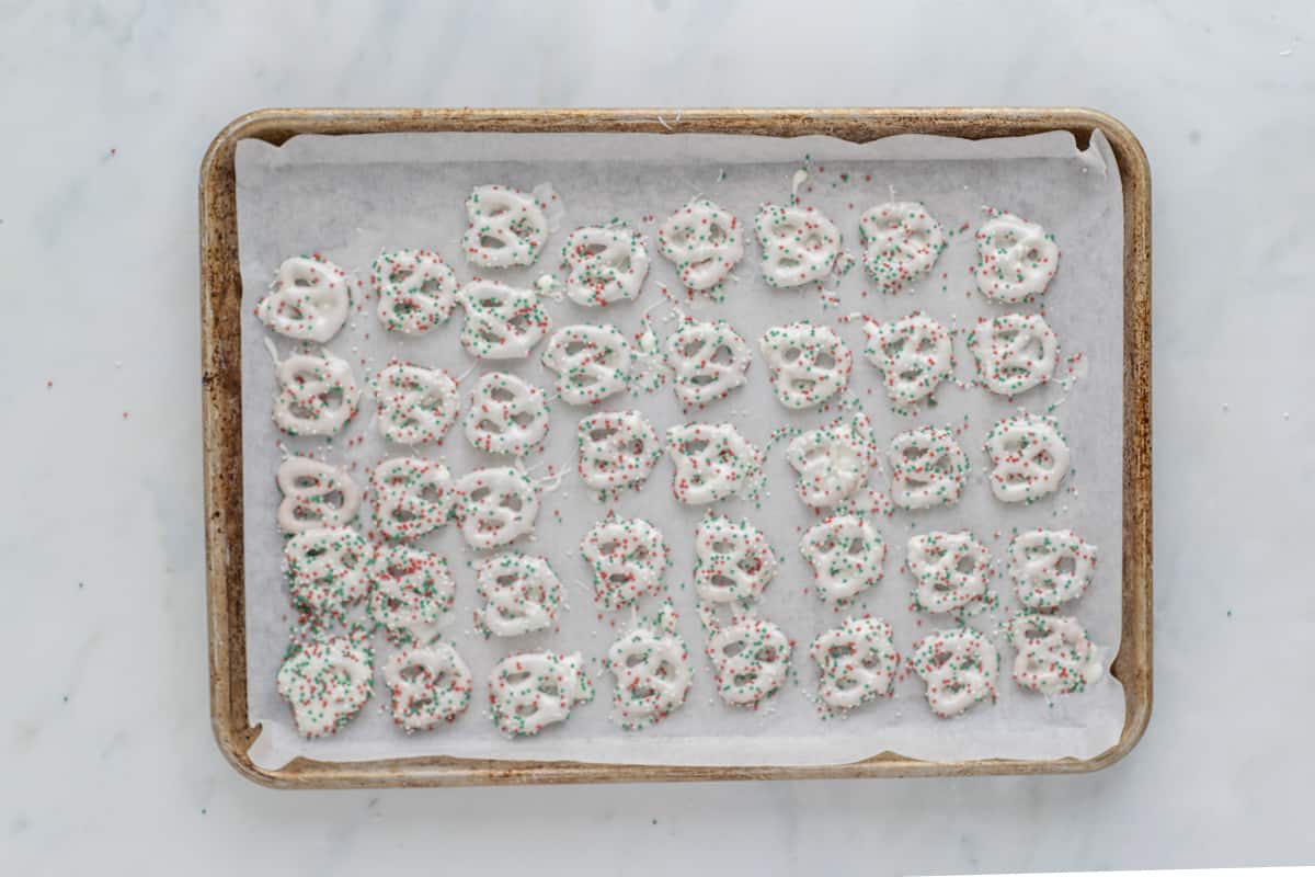 dipped pretzels on a baking sheet.