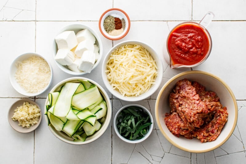 overhead view of ingredients for zucchini ravioli in individual bowls.