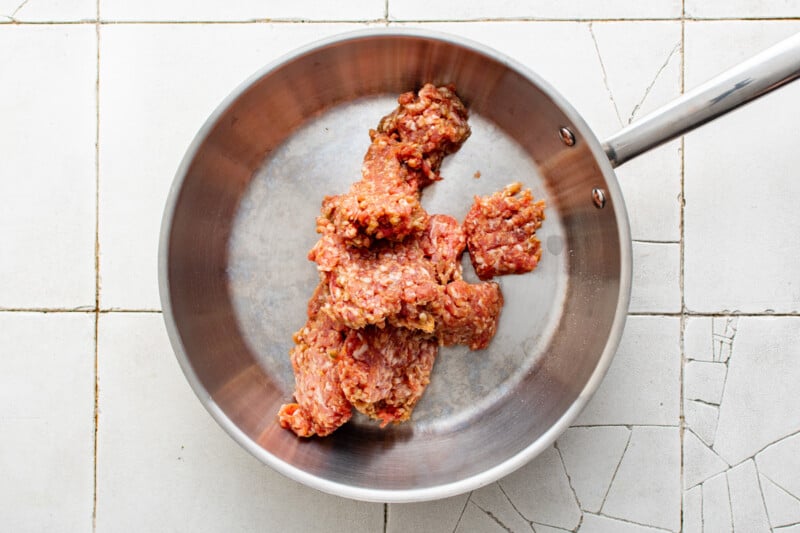 italian sausage in a frying pan.