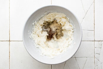 whipped cream cheese and seasonings in a white bowl.