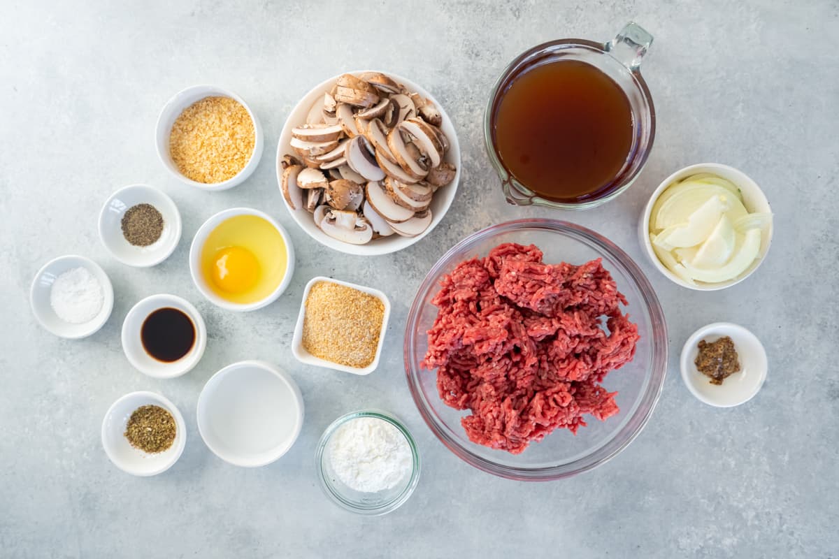 Overhead view of ingredients for Salisbury steak in individual bowls.