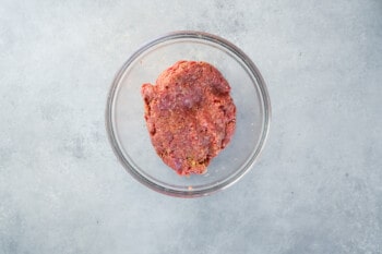 seasoned salisbury steak meat in a glass bowl.