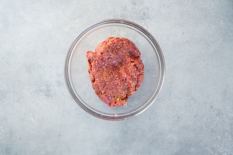 seasoned salisbury steak meat in a glass bowl.