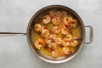saucy shrimp in a frying pan.