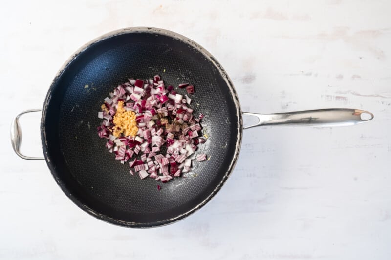 onions in a wok.