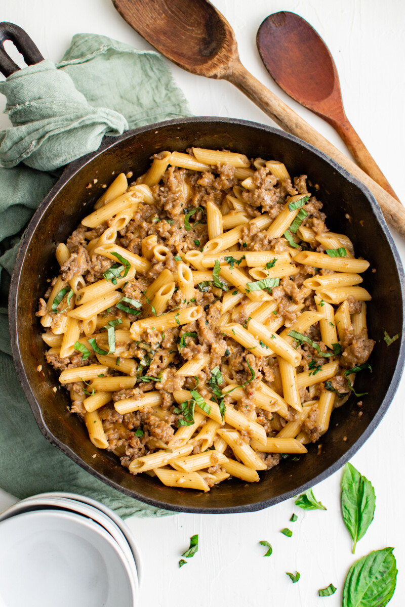 overhead view of sausage pasta in a cast iron pan.