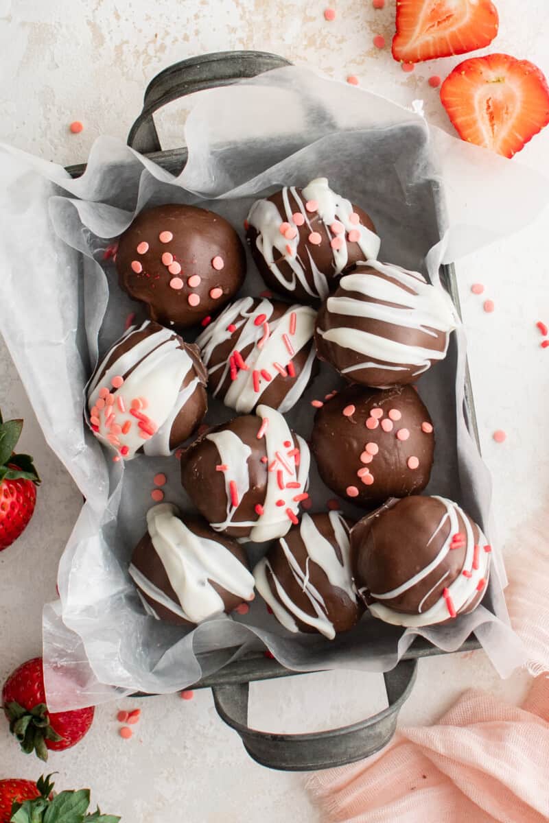 overhead view of strawberry truffles in a small parchment lined basket.