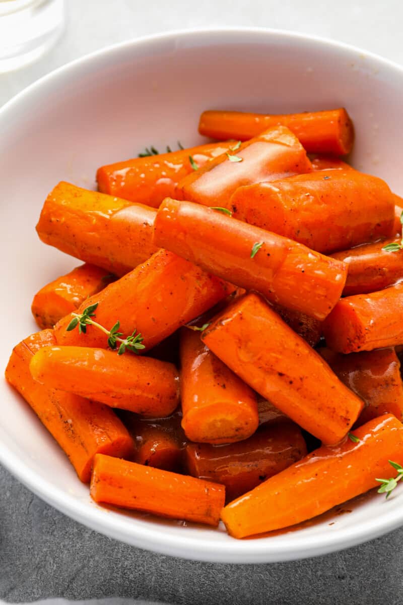 crockpot glazed carrots in a white bowl.