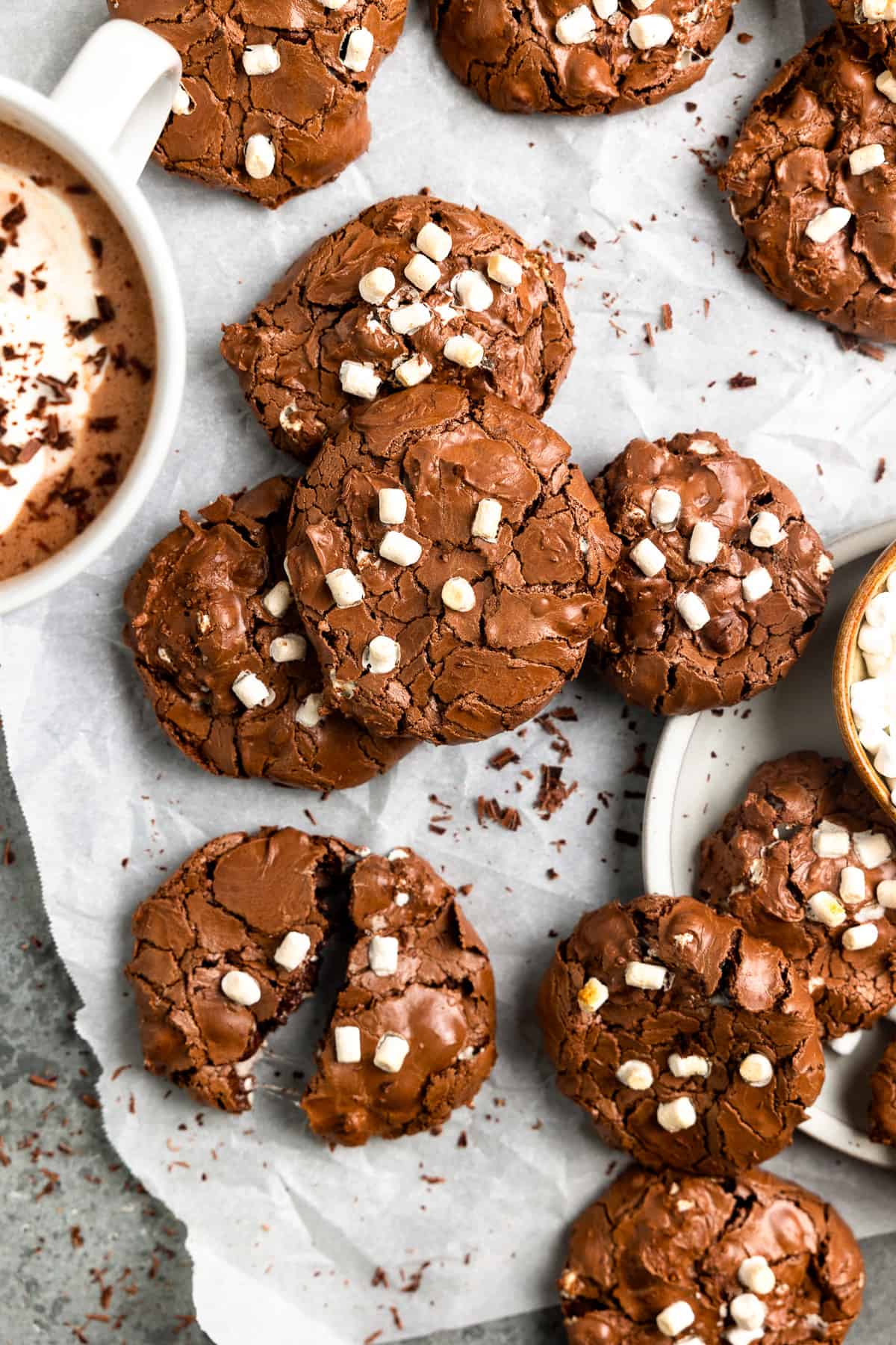overhead view of flourless hot chocolate cookies arranged on crinkled parchment paper.