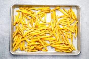 frozen french fries on a baking sheet.
