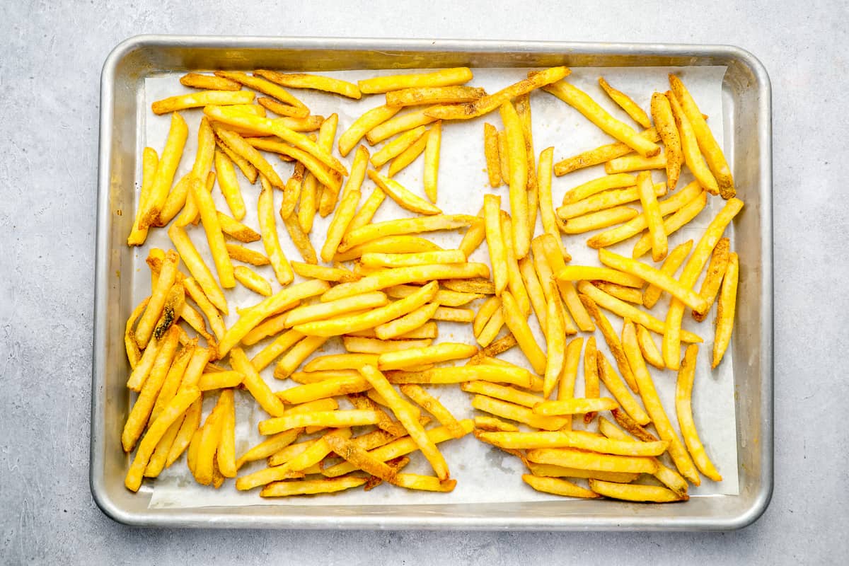 Frozen French fries on a baking sheet. - 11